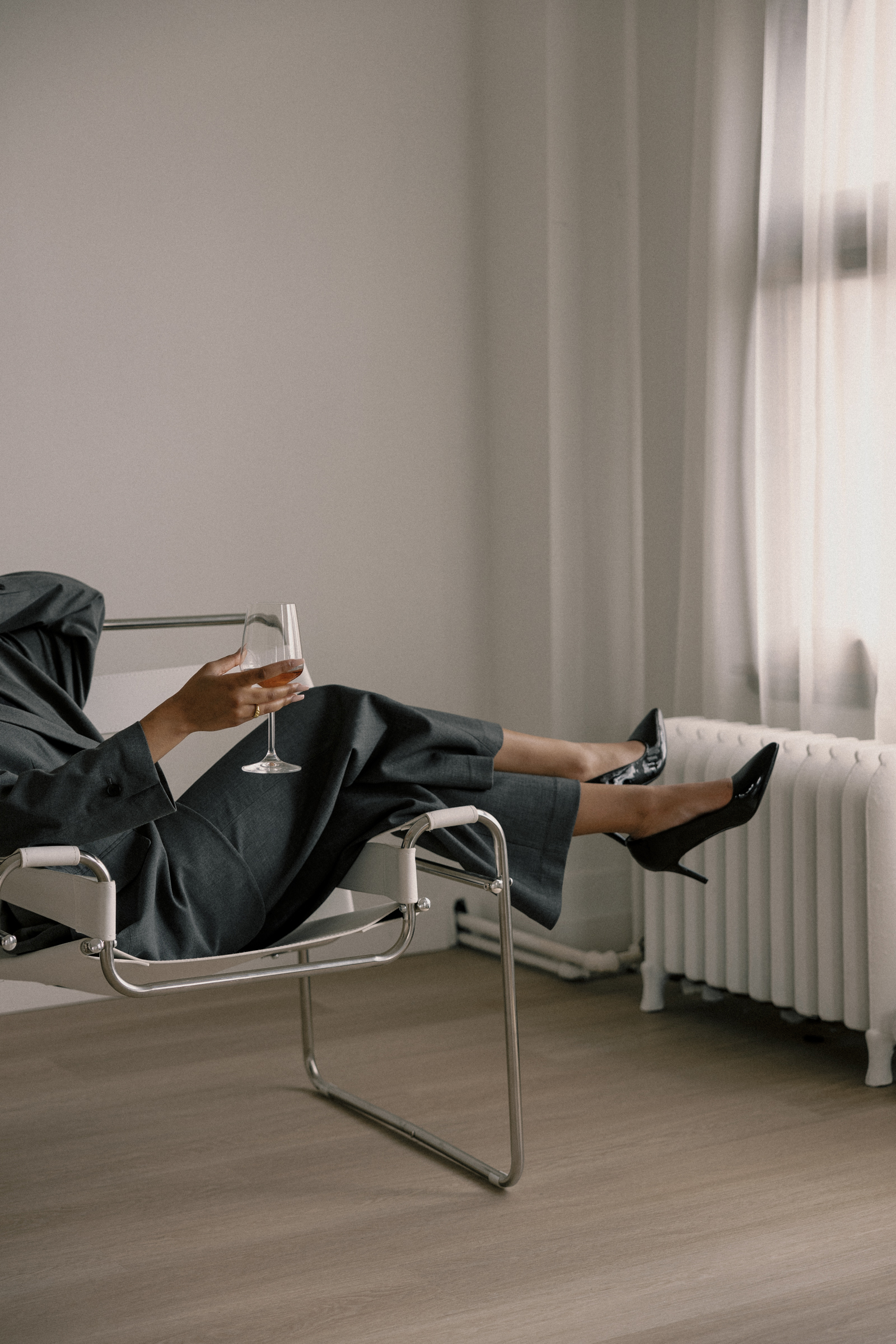 woman in high heels with wine